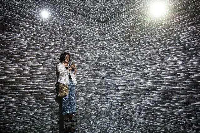 A Chinese girl visits The Future of Today Exhibition themed by “.zip” at Today Art Museum, in Beijing, China, 08 August 2017. The Future of Today Exhibition themed by “.zip” presents the works of different artists and shows various expression formats of art. The exhibition runs from 16 July to 16 September 2017. (Photo by Roman Pilipey/EPA)