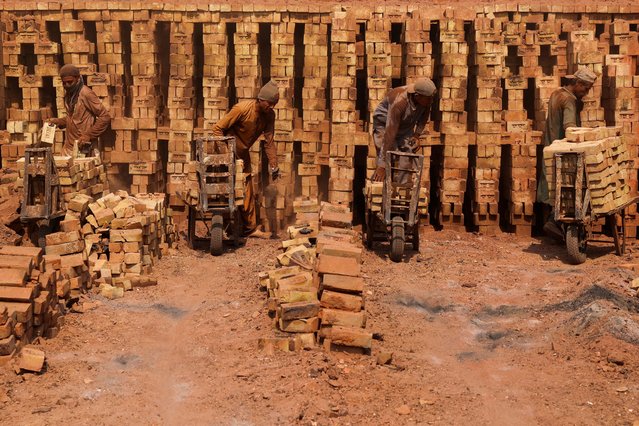 Labourers work at a brick kiln factory on the outskirts of Peshawar, Pakistan on September 18, 2024. (Photo by Fayaz Aziz/Reuters)