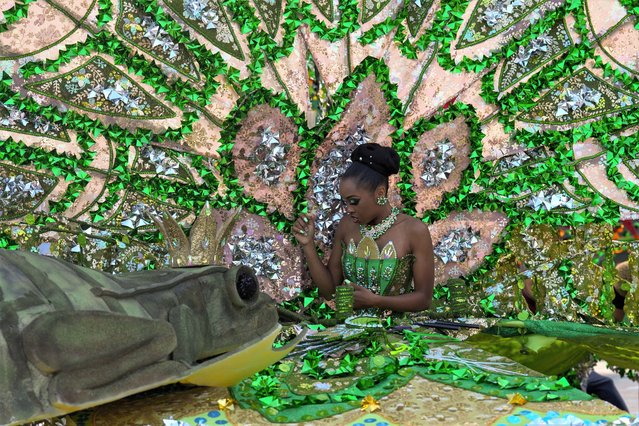 A dancer with “Tribal Carnival” is helped into her costume ahead of the King and Queen Show, part of Toronto Caribbean Caribana Festival, on Thursday, August 3, 2023. (Photo by Canadian Press/Rex Features/Shutterstock)