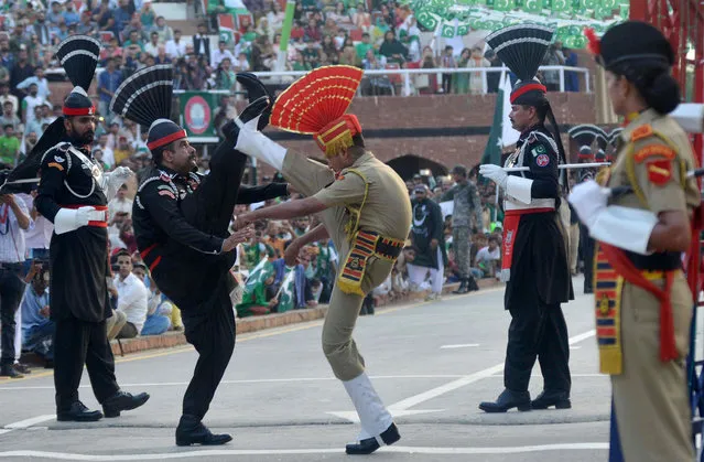 Pakistani Rangers (black) and Indian Border Security Force personnel (brown) perform perform during the daily beating of the retreat ceremony at the India- Pakistan Wagah Border Post, some 35 kms west of Amritsar on August 14, 2017. Pakistan celebrates its independence on August 14, one day before India' s independence day on August 15. (Photo by Narinder Nanu/AFP Photo)