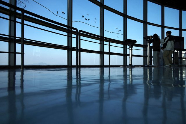 Tourists look toward North Korea's propaganda village Kaepoong from an observation point near the demilitarized zone separating the two Koreas, in Paju, South Korea, on October 31, 2024. (Photo by Kim Hong-Ji/Reuters)