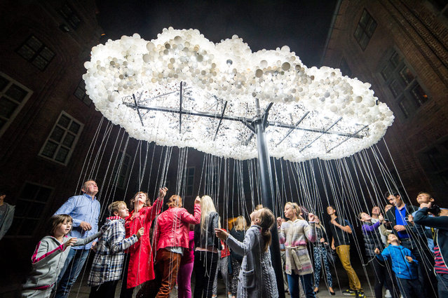 The light installation “Cloud” by Canada's artists Caitlind r.c. Brown and Wayne Garrett is displayed at a street during the Bella Skyway Festival 2015 in Torun, Poland, 25 August 2015.The Festival has been organised in Torun since 2009 and its beginnings are connected with the fact that the town wants to become a European Capital of Culture 2016. (Photo by Tytus Zmijewski/EPA)