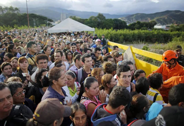 Venezuelans gather to cross the border between Venezuela and Colombia at the Simon Bolivar bridge in San Antonio del Tachira, Venezuela,  to buy supplies Sunday July 17, 2016. (Photo by Ariana Cubillos/AP Photo)