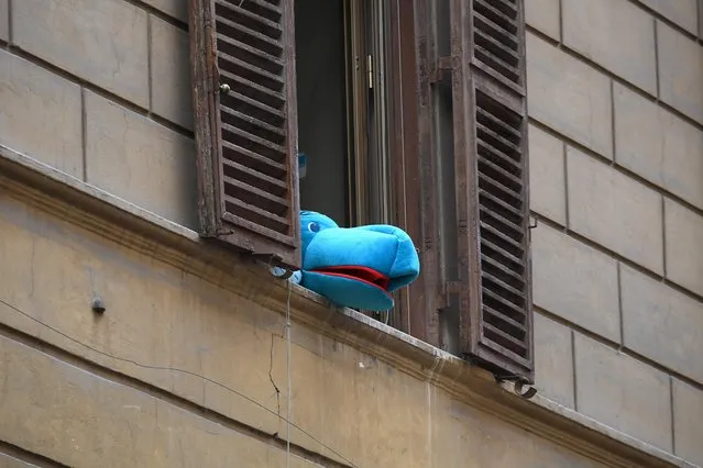 A mascot is seen from a window in Trastevere district as the spread of coronavirus disease (COVID-19) continues, in Rome, Italy, April 2, 2020. (Photo by Alberto Lingria/Reuters)
