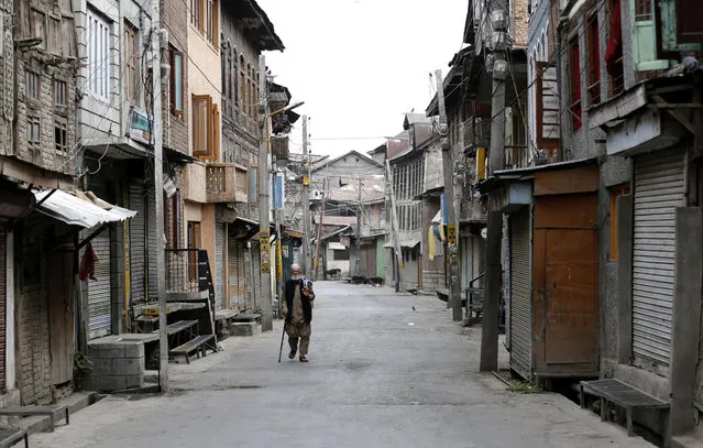 A Kashmiri Muslim man walks on a deserted street during curfew in downtown area of Srinagar, the summer capital of Indian Kashmir, 25 July 2016. According to local news reports a curfew is in place in Anantnag, Baramulla, Kulgam, Pulwama, Shopian districts and some areas in Srinagar City as a precautionary measure in view of the call given by Kashmiri separatists for a march to Anantnag town. So far 50 civilians have been killed and over 3000 injured following protests over the killing of Hizb-ul-Mujahideen commander Burhan Muzaffar Wani and his two associates in a gunfight on 08 July. (Photo by Farooq Khan/EPA)