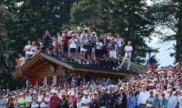 Spectators look on from a rooftop on the 18th hole during Day Four of the Omega European Masters at Crans-sur-Sierre Golf Club on August 28, 2022 in Crans-Montana, Switzerland. (Photo by Richard Heathcote/Getty Images)