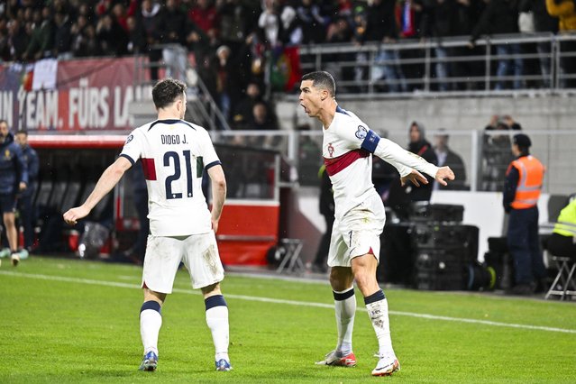 Portugal's Cristiano Ronaldo (R) celebrates after scoring the 0-1 goal during the UEFA Euro 2024 qualification Group J soccer match between Liechtenstein and Portugal, in Vaduz, Liechtenstein, 16 November 2023. (Photo by Gian Ehrenzeller/EPA)