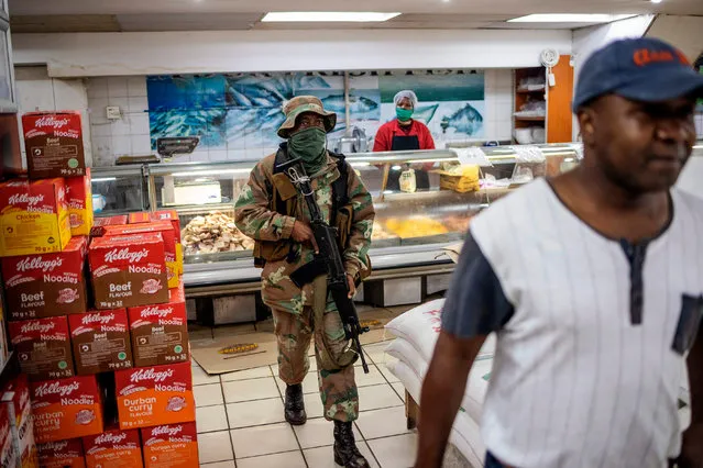 A South African National Defence Force (SANDF) soldier searches for people not wearing face masks in a supermarket in Hillbrow, Johannesburg, on May 1, 2020, during a joint patrol by the South African National Defence Force (SANDF), the South African Police Service (SAPS) and the Johannesburg Metro Police Department (JMPD). South Africa began to gradually loosen its strict COVID-19 coronavirus lockdown on May 1, 2020, after five weeks of restrictions. (Photo by Michele Spatari AFP Photo)