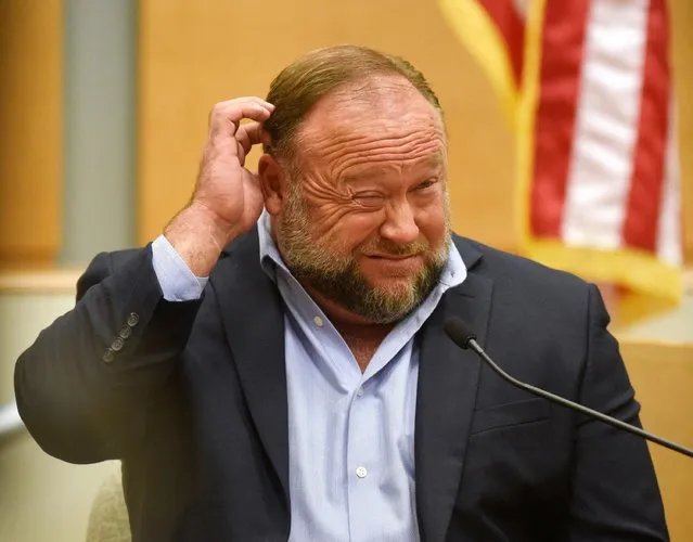 Conspiracy theorist Alex Jones takes the witness stand to testify at the Sandy Hook defamation damages trial at Connecticut Superior Court in Waterbury, Conn. Thursday, September 22, 2022. Jones was found liable last year by default for damages to plaintiffs without a trial, as punishment for what the judge called his repeated failures to turn over documents to their lawyers. The six-member jury is now deciding how much Jones and Free Speech Systems, Infowars‚ parent company, should pay the families for defaming them and intentionally inflicting emotional distress. (Photo by Tyler Sizemore/Hearst Connecticut Media via AP Photo, Pool)