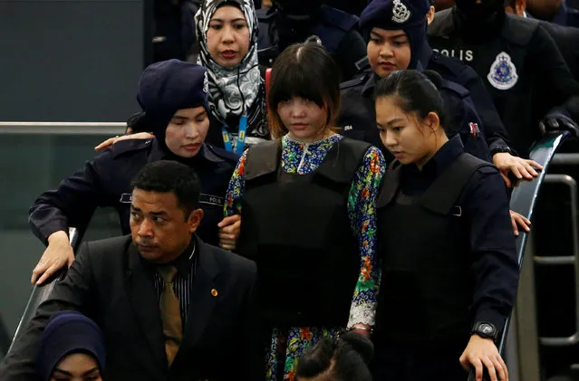 Vietnamese Doan Thi Huong, who is on trial for the killing of Kim Jong Nam, the estranged half-brother of North Korea's leader, is escorted as she revisits the Kuala Lumpur International Airport 2 in Sepang, Malaysia October 24, 2017. (Photo by Lai Seng Sin/Reuters)