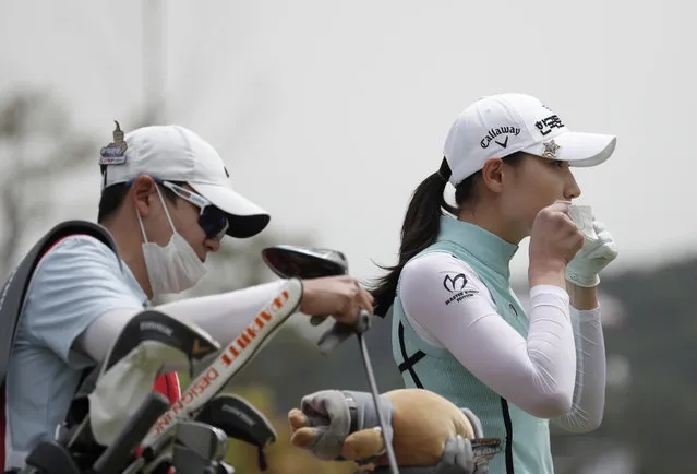 Kim Min-sun of South Korea wears her mask after finishing her tee shot on the first hole during the first round of the 42nd KLPGA Championship golf at the Lakewood Country Club in Yangju, South Korea, Thursday, May 14, 2020. (Photo by Lee Jin-man/AP Photo)