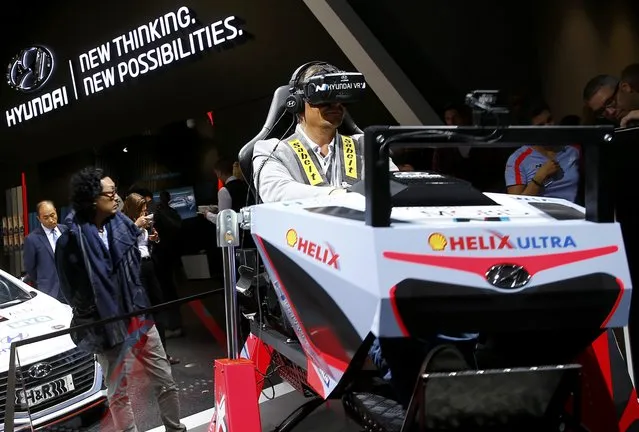 A visitor uses the Hyundai Virtual Drive Simulator during the media day at the Frankfurt Motor Show (IAA) in Frankfurt, Germany September 15, 2015. (Photo by Kai Pfaffenbach/Reuters)