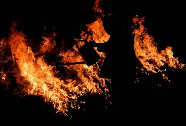 A Taoist devotee pours gasoline into the fire on the final day of the Chinese Nine Emperor Gods festival at a temple in Ampang, Selangor, Malaysia on October 4, 2022. (Photo by Hasnoor Hussain/Reuters)