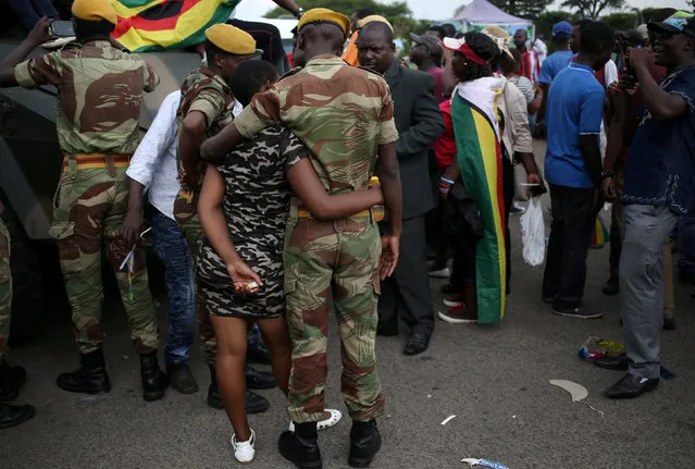A member of Zimbabwe military chats with a local after the swearing in of Emmerson Mnangagwa as Zimbabwe's new president in Harare, Zimbabwe, November 24, 2017. (Photo by Siphiwe Sibeko/Reuters)
