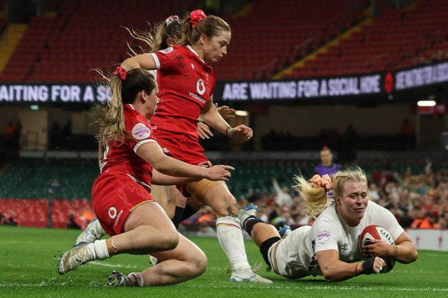 England's Abi Burton dives over the line to score the final try of the Women's Six Nations international rugby union match between Wales and England at the Principality Stadium in Cardiff, south Wales on March 29, 2025. (Photo by Adrian Dennis/AFP Photo)