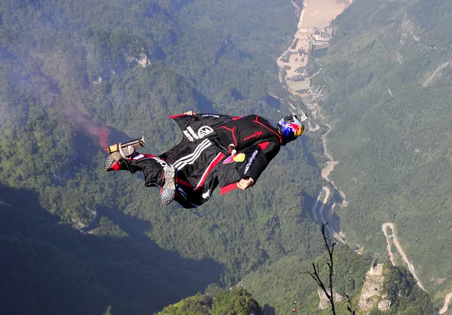 Colombian wingsuit flyer Jonathan Florez, champion of the second Wingsuit Flying World Championship, spreads his wings over a mountain at Tianmen Mountain National Park in Zhangjiajie, Hunan province October 12, 2013. (Photo by Reuters/China Daily)