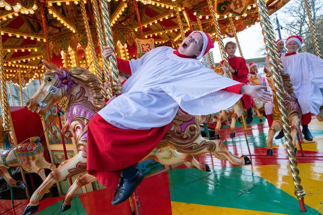 Picture dated November 18th, 2022 shows Choristers from Ely Cathedral in Cambridgeshire going for a spin on the traditional carousel at the city's Christmas market today after early morning choir practice on Friday. (Phoot by Geoff Robinson Photography)
