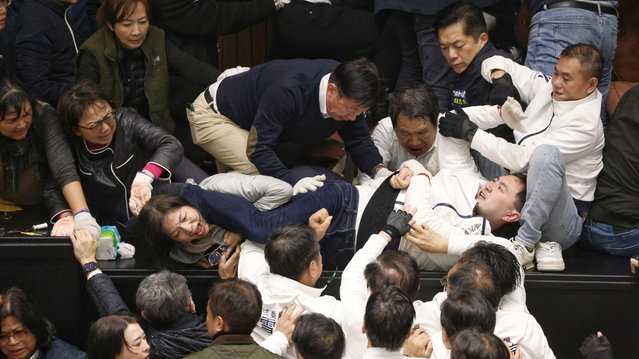 Lawmakers from the Democratic Progressive Party (DPP) and opposition party Kuomintang (KMT) (in white) brawl over the third reading of amendments to the Civil Servants Election and Recall Act and other controversial bills at the Legislative Yuan in Taipei on December 20, 2024. (Photo by I-Hwa Cheng/AFP Photo)