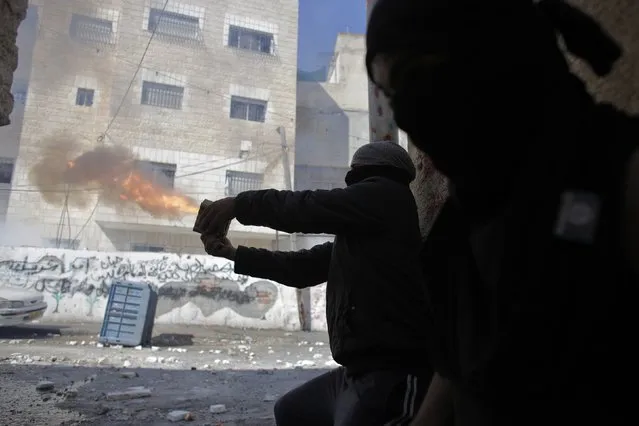 Palestinians aim fireworks towards Israeli police forces during clashes in Abu Tor neighborhood at east Jerusalem October 30, 2014. Israeli police shot dead a Palestinian on Thursday after he fired at them resisting arrest in East Jerusalem hours after the attempted assassination of a far-right Israeli activist, police said. (Photo by Ammar Awad/Reuters)