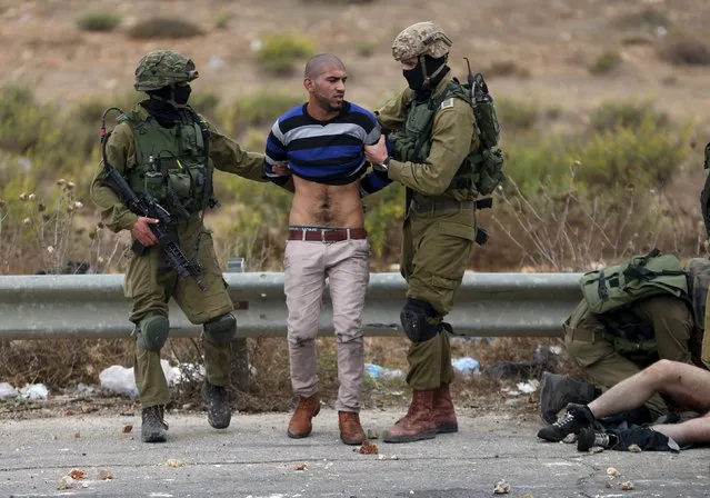 Israeli soldiers detain a Palestinian protester during clashes near the Jewish settlement of Bet El, near the West Bank city of Ramallah, October 7, 2015. (Photo by Mohamad Torokman/Reuters)
