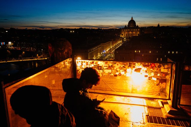 A picture taken from a terrace shows St Peter's basilica at sunset, in Rome on February 27, 2025. (Photo by Dimitar Dilkoff/AFP Photo)
