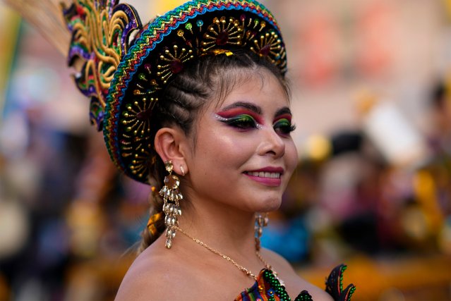 A “La Morenada'” dancer smiles while marching in the annual parade honoring the “Lord of Great Power”, in La Paz, Bolivia, Saturday, May 25, 2024. Bolivians celebrate one of the country's biggest and most extravagant religious festivals which pays tribute to Jesus Christ in a fusion of Indigenous beliefs and Catholicism. (Photo by Juan Karita/AP Photo)