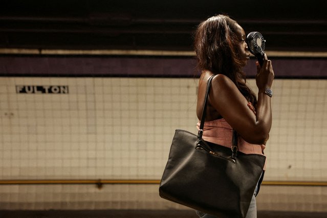A woman hold a handheld fan on a subway platform during a heatwave affecting the U.S. Northeast in New York City on June 25, 2025. (Photo by Jeenah Moon/Reuters)