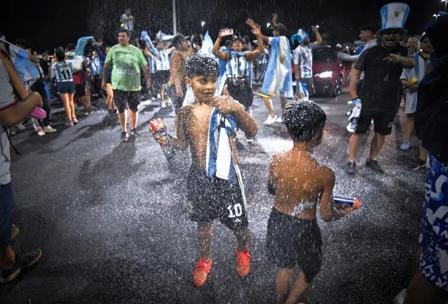 Young fans are seen outside the Association of Argentinian Football Headquarters ahead of the Argentina team bus arrival in Buenos Aires, Argentina on December 19, 2022. (Photo by Mariana Nedelcu/Reuters)