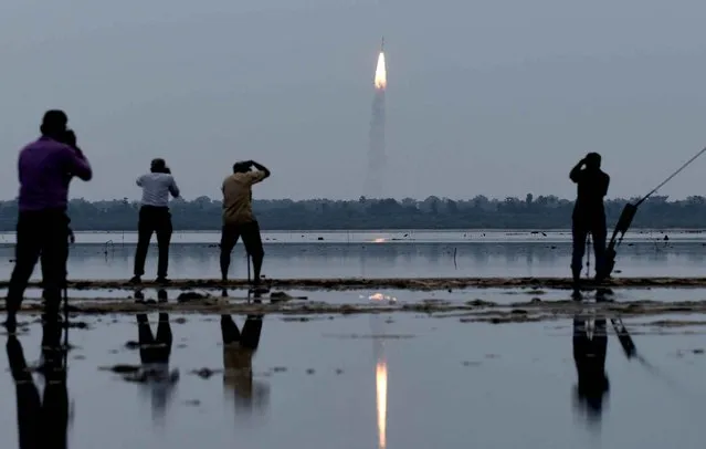 Indian residents photograph the launch of the Indian Space Research Organisation (ISRO) Polar Satellite Launch Vehicle (PSLV-C35), carrying equipment which will be used to monitor oceans and weather at Sriharikota in the state of Andhra Pradesh on September 26, 2016. The rocket is also carrying satellites from Algeria, Canada and the US. (Photo by Arun Sankar/AFP Photo)