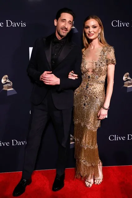 US actor Adrien Brody (L) and English fashion designer Georgina Chapman arrive for the Recording Academy and Clive Davis pre-Grammy gala at the Beverly Hilton hotel in Beverly Hills, California on February 4, 2023. (Photo by Michael Tran/AFP Photo)