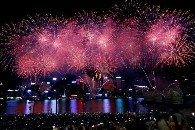 Thousands of people watch as fireworks explode over the Victoria Harbour of Hong Kong to mark China's National Day, China October 1, 2016. (Photo by Bobby Yip/Reuters)