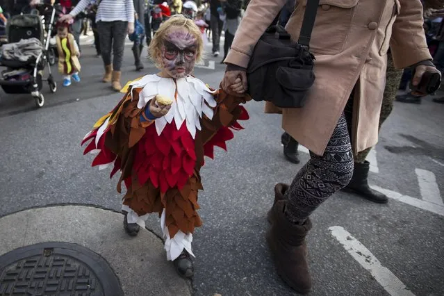 A child dressed as a bird takes part in the Children's Halloween day parade at Washington Square Park in the Manhattan borough of New York October 31, 2015. (Photo by Carlo Allegri/Reuters)