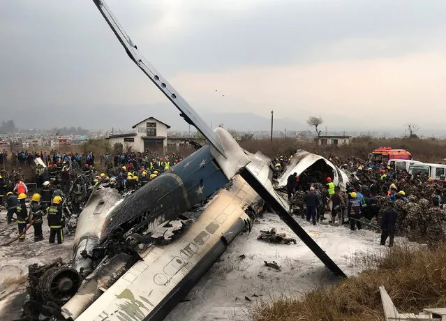 Wreckage of an airplane is pictured as rescue workers operate at Kathmandu airport, Nepal March 12, 2018. (Photo by Navesh Chitrakar/Reuters)