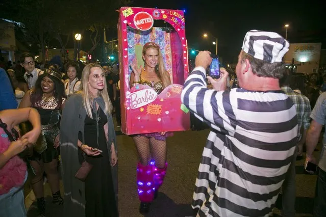 A woman dressed in a Barbie costume poses at the West Hollywood Halloween Costume Carnaval, which attracts nearly 500,000 people annually, in West Hollywood, California October 31, 2015. (Photo by Jonathan Alcorn/Reuters)