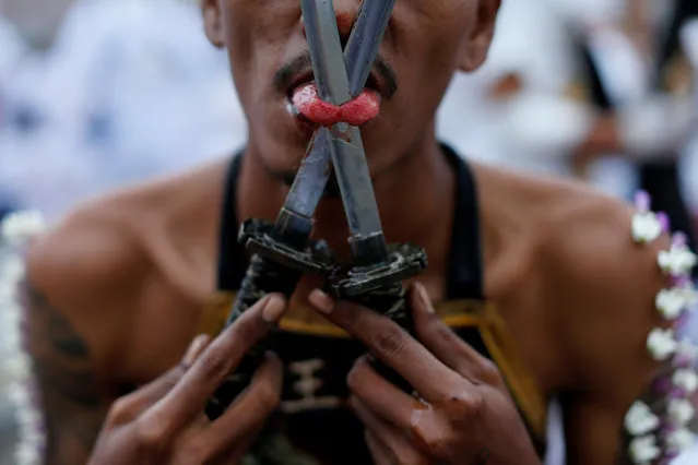 A devotee of the Chinese  Bang Neow shrine with his tongue pierced takes part in a procession celebrating the annual vegetarian festival in Phuket, Thailand, October 6, 2016. (Photo by Jorge Silva/Reuters)