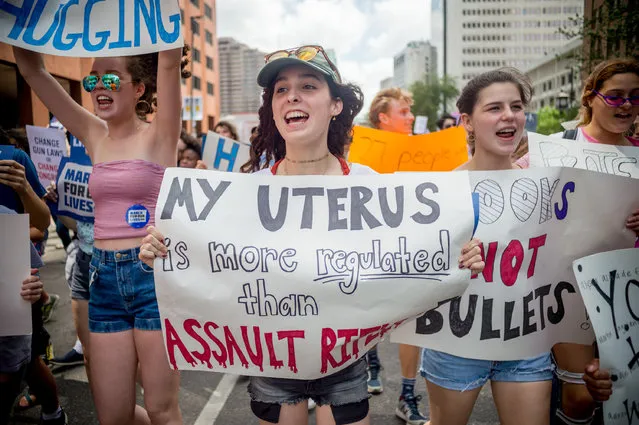 People take part in the March For Our Lives rally against gun violence in New Orleans, Louisiana on March 24, 2018. Galvanized by a massacre at a Florida high school, hundreds of thousands of Americans are expected to take to the streets in cities across the United States on Saturday in the biggest protest for gun control in a generation. (Photo by Emily Kask/AFP Photo)
