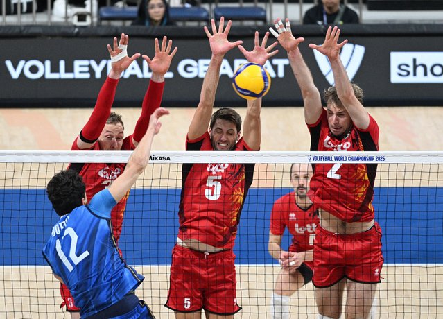 Italy's Mattia Bottolo in action with Belgium's Ferre Reggers and Pieter Coolman at SM Mall of Asia Arena in Pasay City, Philippines on September 24, 2025. (Photo by Noel Celis/Reuters)