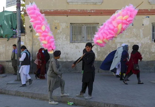 Vendors selling cotton candy wait for customers in Kabul, Afghanistan, Thursday, November 5, 2020. (Photo by Rahmat Gul/AP Photos)
