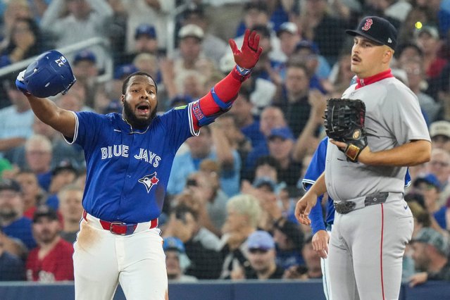 Toronto Blue Jays' Vladimir Guerrero Jr. Photo: left) celebrates in front of Boston Red Sox first baseman Nathaniel Lowe Photo: 37) after hitting a single during sixth inning MLB baseball action in Toronto on Thursday September 25, 2025. (Photo by Chris Young/The Canadian Press via AP Photo)