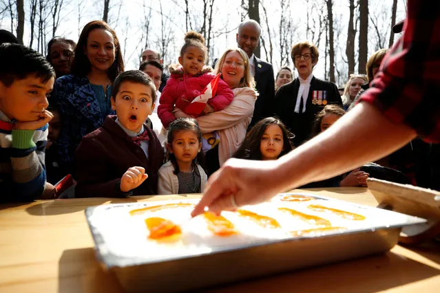 New Canadian citizen David Alfonso, 8, reacts as maple taffy is prepared for new Canadians following a citizenship ceremony at the Vanier Sugar Shack in Ottawa, Ontario, Canada, April 11, 2018. (Photo by Chris Wattie/Reuters)