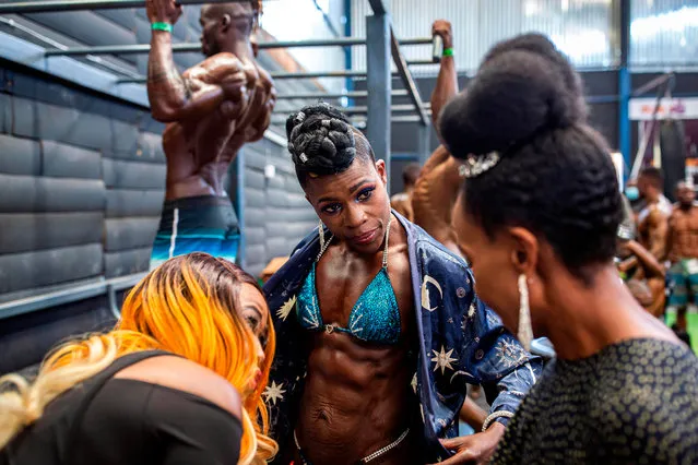 Bodybuilders gather in the backstage warming up area before taking aprt in the Iron Fit Bodybuilding competition in Nairobi on December 05, 2020. 130 participants from all across East Africa took part in the second edition of this competition which included categories like Bikini, Figure, Physique and Bodybuilding. (Photo by Patrick Meinhardt/AFP Photo)