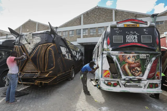 Graffiti designers paint matatus at the Choda fabricators garage in Nairobi, Kenya, 05 April 2018. The Matatu culture is very big in Kenya, the minibuses are decorated with colorful graffiti inside and outside and most of them are equipped with tv screens, high-speed internet, and power sockets. The word matatu is a Swahili term meaning “three”, coined in the 1970s to describe the then-new mode of transport when people used to pay three pennies to get from one point to another in the minibuses. But these buses, privately-owned taxis shared by multiple passengers, have evolved from being a mere mode of transport to a way of life, spreading from urban hubs to all corners of the East African nation. (Photo by Daniel Irungu/EPA/EFE)