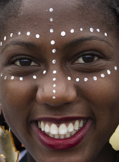 A woman smiles during the Women Black March ahead of the National Black Consciousness Day in Brasilia, Brazil, November 18, 2015. The National Black Consciousness Day will be held on November 20, throughout Brazil, where some 45 percent of the population of 190 million are black or of black origin, according to organizers. (Photo by Joedson Alves/Reuters)