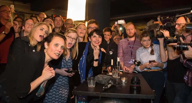 Politician and co founder of Iceland's Pirate Party Birgitta Jonsdottir (C), Asta Gudrun Helgadottir (2nd,L) and fellow activists reacts as the election results are announced at their election gathering in Reykjavik, Iceland on October 25, 2016. Iceland on Sunday faced a wrangle over its next government after the anti-establishment Pirate Party and its allies gained ground but fell short of a majority in snap elections sparked by the Panama Papers scandal. (Photo by Halldor Kolbeins/AFP Photo)