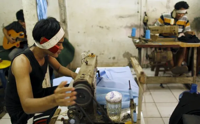 Workers sew clothes in a small industrial settlement in Jakarta in this December 11, 2012 file photo. Indonesia is expected to release PMI data this week. (Photo by Yusuf Ahmad/Reuters)