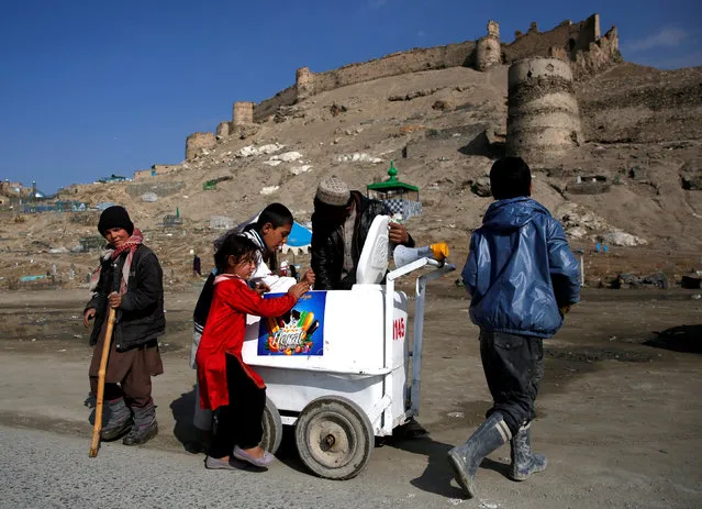 Children buy ice cream in Kabul, Afghanistan March 5, 2018. (Photo by Mohammad Ismail/Reuters)
