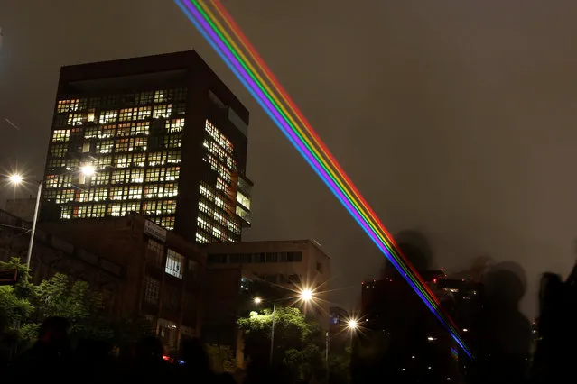 Rainbow-colored laser lights projected across the city center are seen during the International Festival of Lights in Mexico City, Mexico November 11, 2016. (Photo by Carlos Jasso/Reuters)