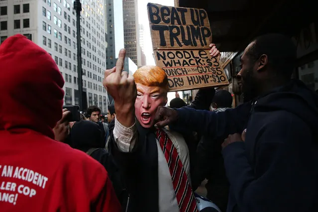 A man in a Donald Trump mask joins hundreds of other protesters and activists as they march during a demonstration near a midtown hotel which is hosting a black-tie fund-raiser for the state Republican Party on April 14, 2016 in New York City. (Photo by Spencer Platt/Getty Images)