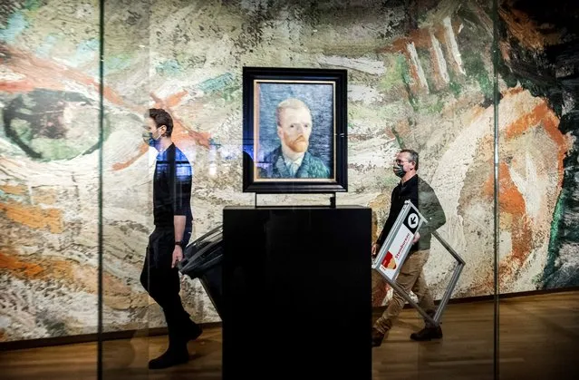 Employees walk past a self-portrait of late Dutch painter Vincent van Gogh as they carry materials used to set up a polling booth at the Van Gogh Museum in Amsterdam, on March 16, 2021 on th eve of the parliamentary elections. Museums in Netherlands will be used as polling sation for the Parliamentary elections of March 17, 2021. (Photo by Koen van Weel/AFP Photo/Profimedia)