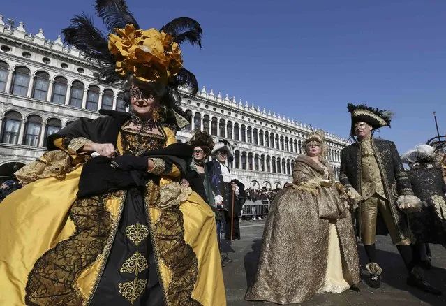 Masked revellers pose in Saint Mark square during carnival in Venice February 8, 2015. (Photo by Stefano Rellandini/Reuters)
